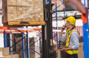 pallets at a warehouse and a warehouse employee.